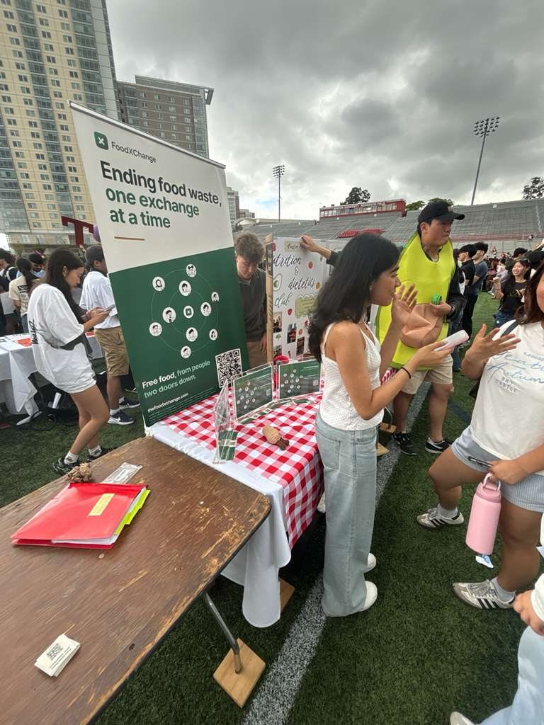 FoodXChange banner and outreach table at an outdoor campus event