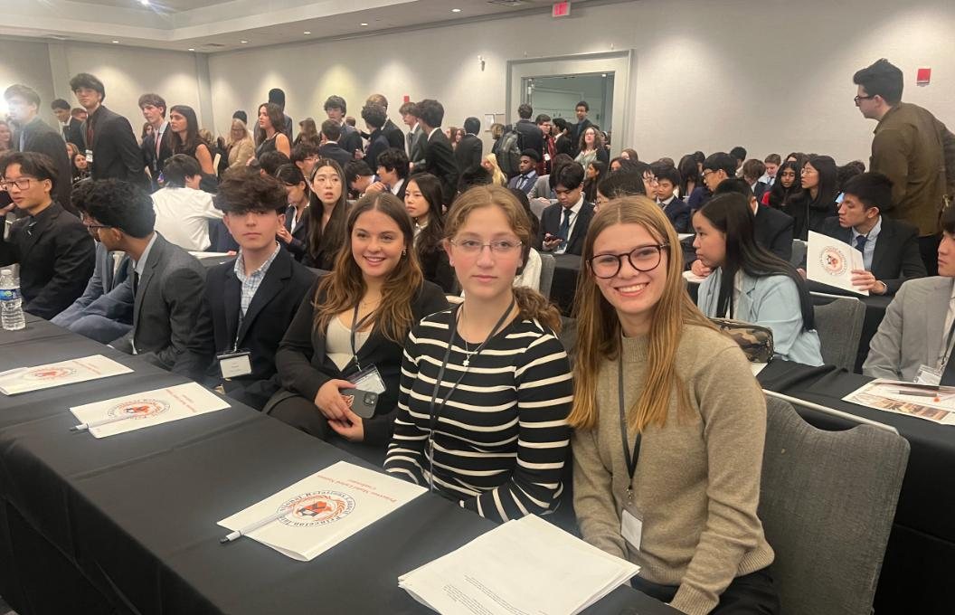 Model UN delegates seated at a conference