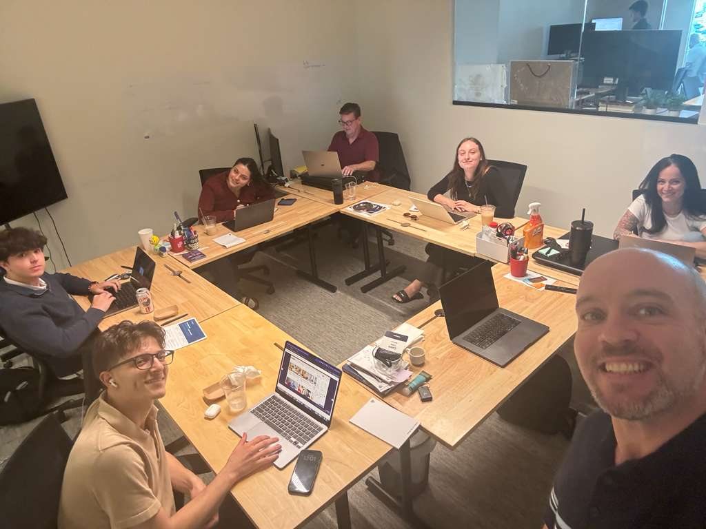 Max and colleagues working together around a conference table